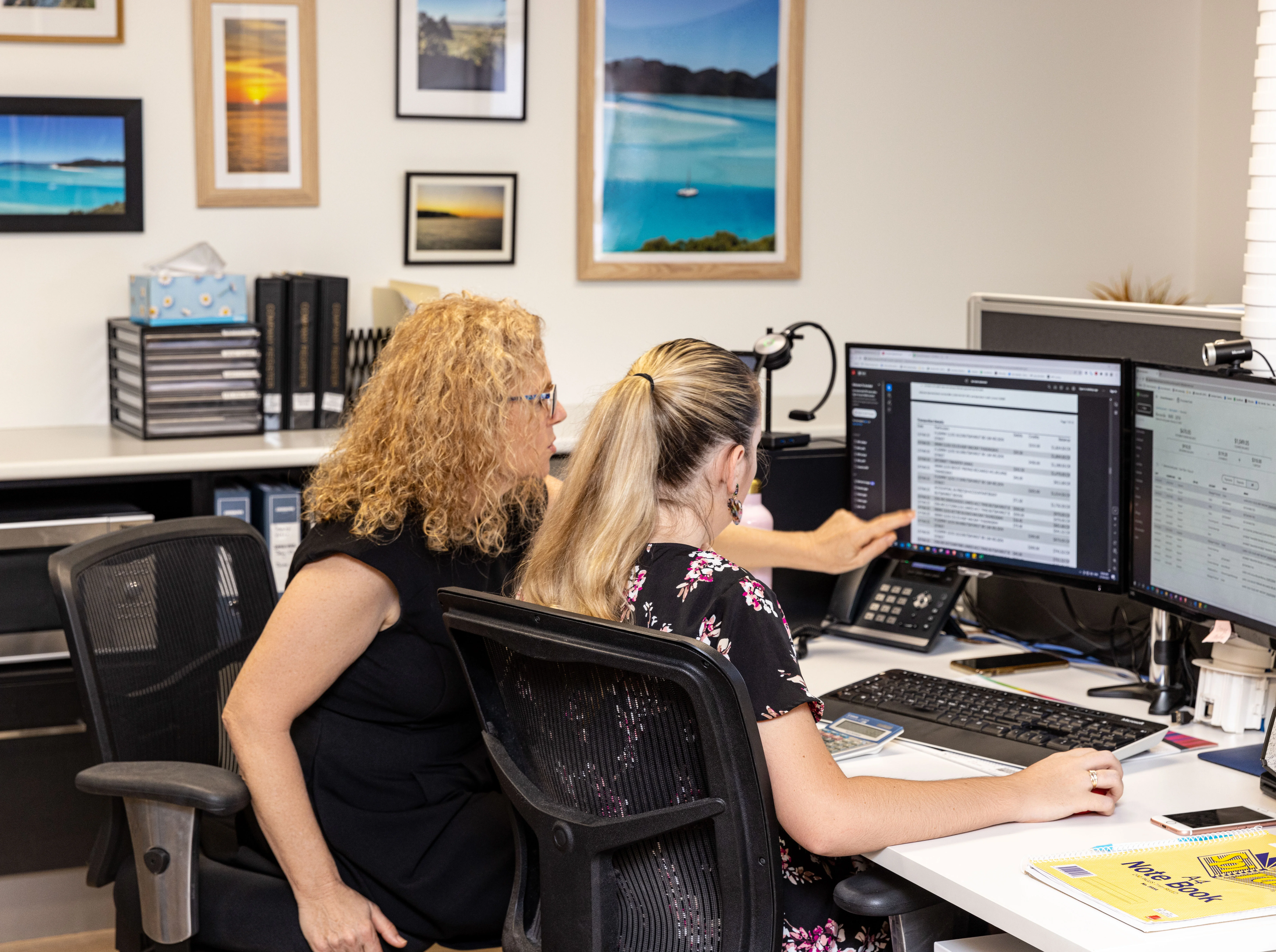 Jen and Erin reviewing business financials with a client