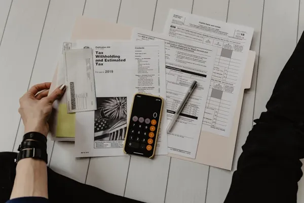 Bookkeeping documents, calculator, and financial paperwork