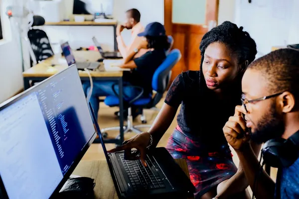 Team collaborating on software training at a computer