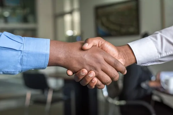 Professional handshake symbolising seamless account handover