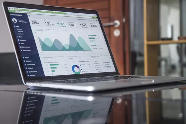Laptop displaying financial dashboard with charts and analytics
